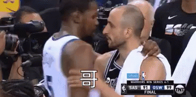 Two Basketball Players Are Hugging Each Other During A Basketball Game . GIF