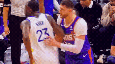 Two Basketball Players Are Hugging Each Other On The Court . GIF
