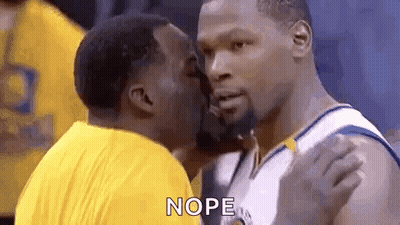 Two Basketball Players Are Kissing Each Other During A Game . GIF