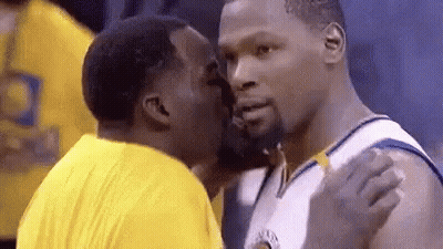 Two Basketball Players Are Kissing Each Other On The Cheeks . GIF