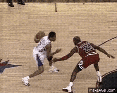 Two Basketball Players Are Playing A Game Of Basketball And One Of Them Has The Number 23 On His Back GIF