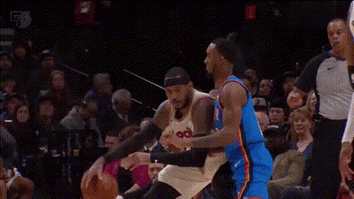 Two Basketball Players Are Playing A Game Of Basketball In Front Of A Crowd . One Player Is Wearing A Number 23 Jersey . GIF