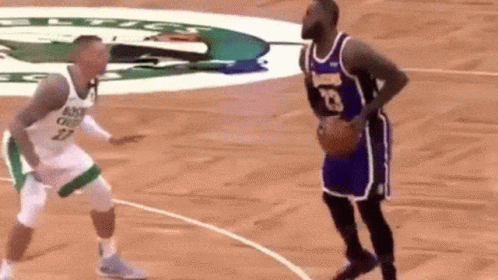 Two Basketball Players Are Playing A Game Of Basketball On A Court . One Of The Players Has The Number 23 On His Jersey  GIF