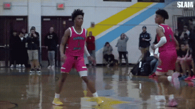 Two Basketball Players Are Playing A Game Of Basketball On A Court . GIF