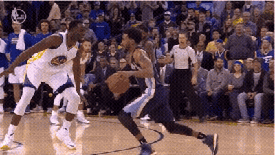 Two Basketball Players Are Playing A Game Of Basketball On A Court While A Referee Watches . GIF