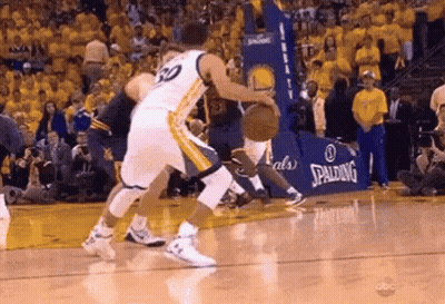 Two Basketball Players Are Playing A Game Of Basketball On A Court With A Spalding Ad In The Background . GIF