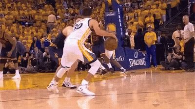 Two Basketball Players Are Playing A Game Of Basketball On A Court With A Spalding Sign In The Background . GIF