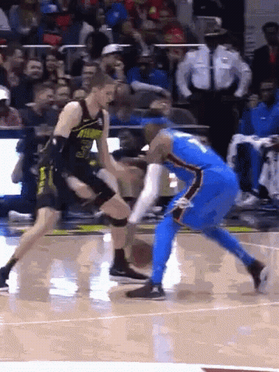 Two Basketball Players Are Playing A Game On A Court GIF