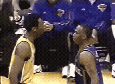 Two Basketball Players Are Standing Next To Each Other On The Court GIF