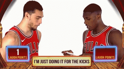 Two Basketball Players Are Standing Next To Each Other With A Sign That Says " Laugh Points " GIF
