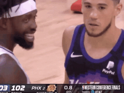 Two Basketball Players Are Talking To Each Other During A Game Sponsored By At & T GIF