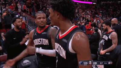 Two Basketball Players From The Houston Rockets Are Hugging Each Other GIF