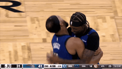 Two Basketball Players Hugging Each Other During A Game With A Score Of 41 To 24 GIF