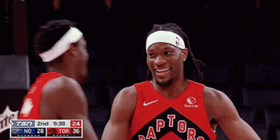 Two Basketball Players Hugging Each Other In Front Of A Sprite Sign GIF