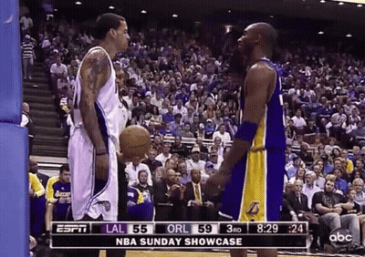 Two Basketball Players In Front Of Crowd GIF