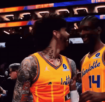 Two Basketball Players In Yellow Charlotte Uniforms GIF