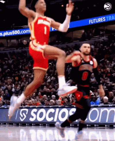 Two Basketball Players Jumping In Front Of Socios.com Sign GIF