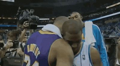 Two Basketball Players Kissing In Front Of Crowd GIF