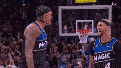 Two Basketball Players Laughing In Magic Jerseys GIF