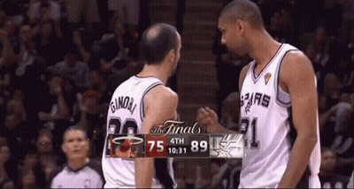 Two Basketball Players Near Scoreboard GIF