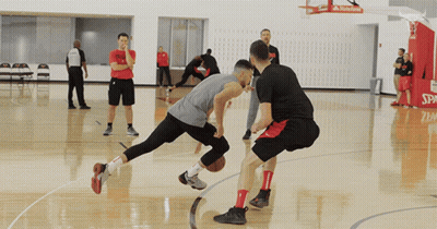 Two Basketball Players On A Court With The Word Spalding On The Hoop GIF