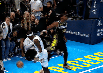 Two Basketball Players On Court With Crowd GIF
