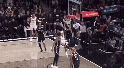 Two Basketball Players One Kicking Another GIF