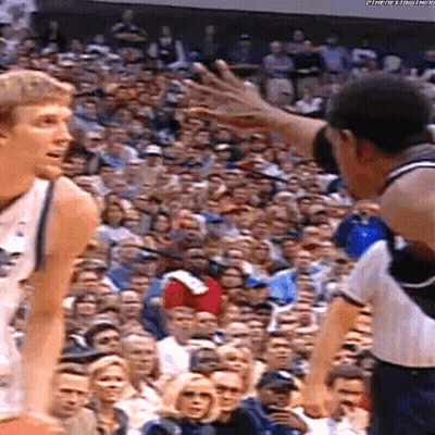 Two Basketball Players Playing In Front Of Crowd GIF