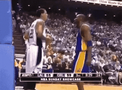 Two Basketball Players Standing In Front Of Crowd GIF