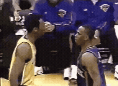 Two Basketball Players Standing Next To Each Other On A Court GIF
