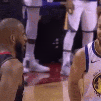 Two Basketball Players Standing Together On Court GIF