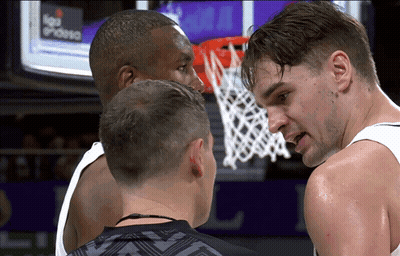 Two Basketball Players Talking In Front Of Liga Endesa Screen GIF