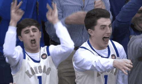 Two Basketball Players Wearing Kansas Jerseys Are Celebrating GIF