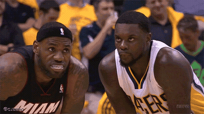 Two Basketball Players Wearing Miami Jerseys Are Looking At Each Other GIF