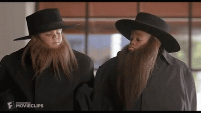 Two Bearded Children In Hats And Coats GIF
