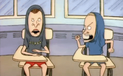 Two Beavis And Butthead Cartoon Characters Are Sitting At Desks GIF