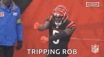 Two Bengals Football Players Hudson And 87 Are Hugging Each Other During A Game . GIF