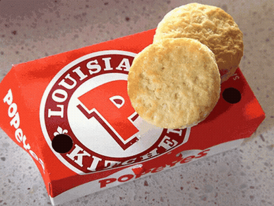 Two Biscuits In A Box That Says Louisia Kitchen On It GIF