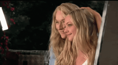 Two Blonde Women Are Standing Next To Each Other And Smiling At The Camera . GIF