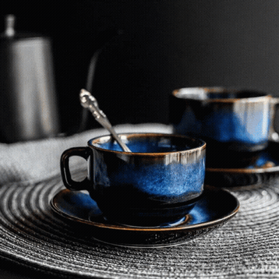 Two Blue Cups And Saucers With Silver Spoon GIF