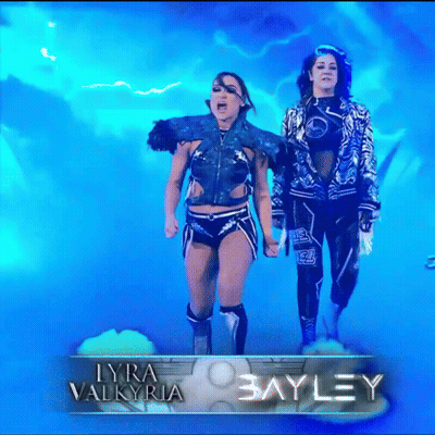 Two Blue-Haired Women Walking Red Carpet Past The Next Thing Sign GIF