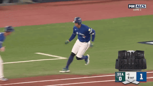 Two Blue Jays Baseball Players Shake Hands During A Game On Fox Alcs GIF