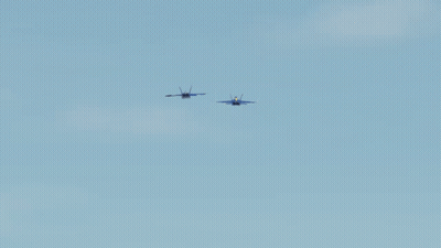 Two Blue Jets Flying In A Blue Sky GIF