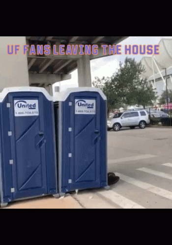 Two Blue Portable Toilets In Parking Lot GIF