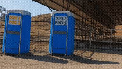 Two Blue Portable Toilets With The Words Zone A Pod 2 And Zone A Pod 1 GIF