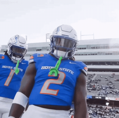 Two Boise State Football Players Wearing Blue Jerseys GIF