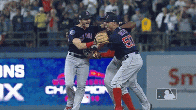 Two Boston Red Sox Players Are Hugging Each Other On The Field GIF