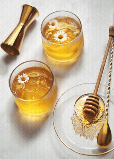 Two Bowls Of Honey With Daisies And Honey Dipper GIF