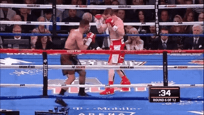 Two Boxers Are Fighting In A Boxing Ring And The Time Is 34 Seconds . GIF