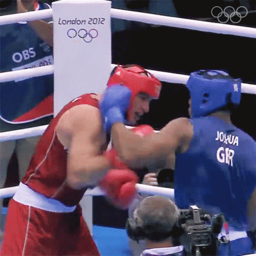 Two Boxers Are Fighting In A Boxing Ring With A London 2012 Sign In The Background GIF